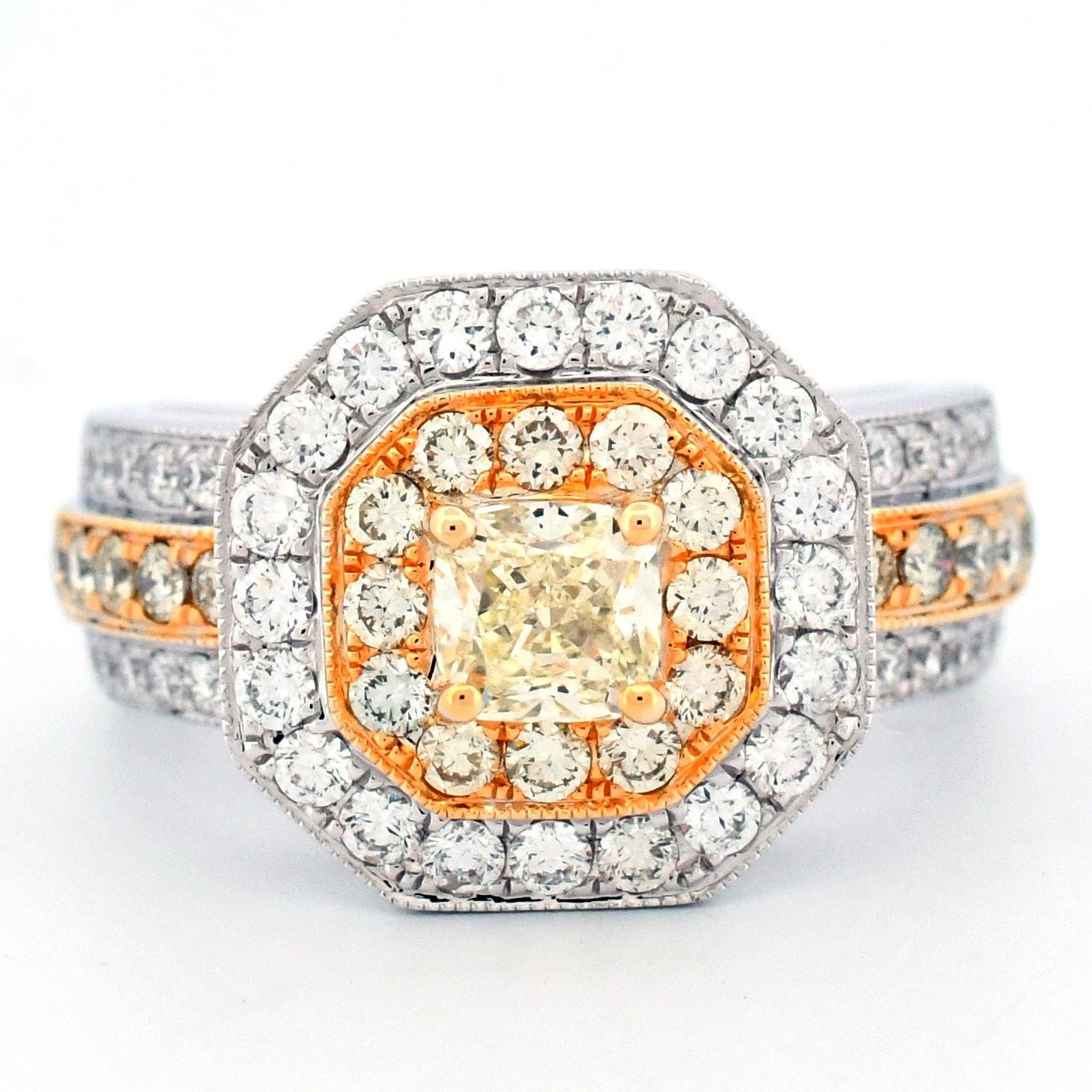 Diamond ring with a yellow center stone and surrounding diamonds